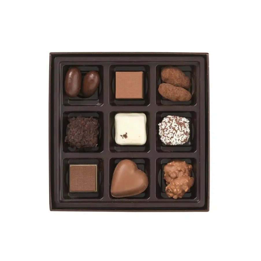 Assorted chocolates in a brown box on a white background